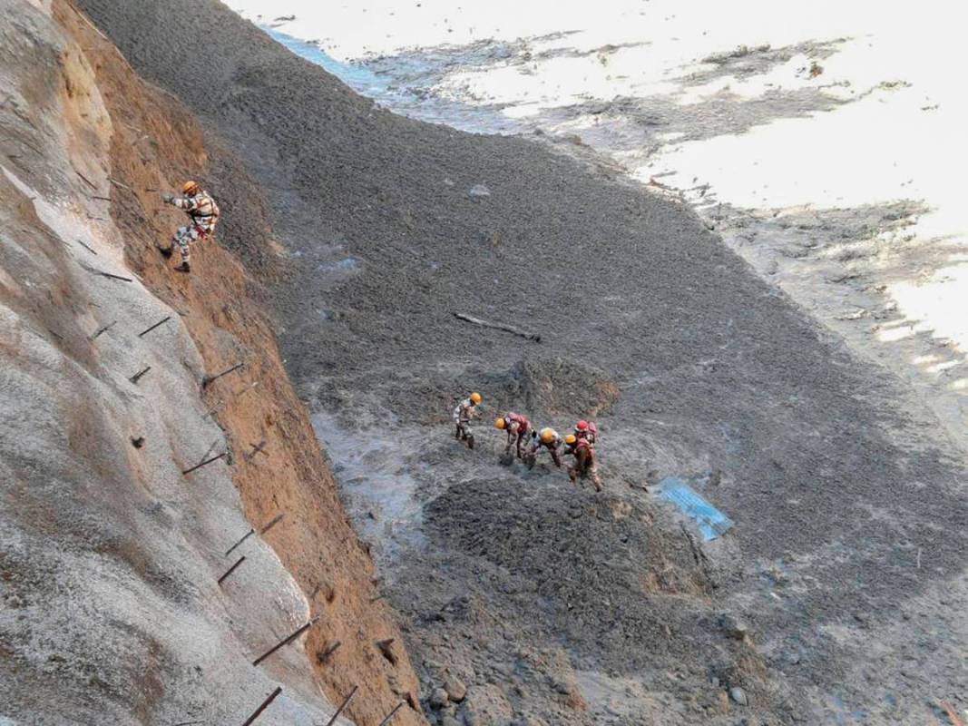This photograph provided by Indo Tibetan Border Police (ITBP) shows ITBP personnel begin rescue ...