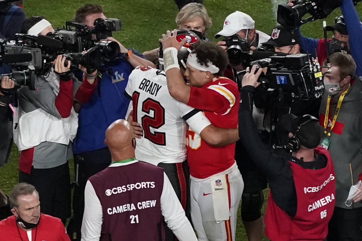 Tampa Bay Buccaneers' Tom Brady (12) and Kansas City Chiefs' Patrick Mahomes (15) greet followi ...