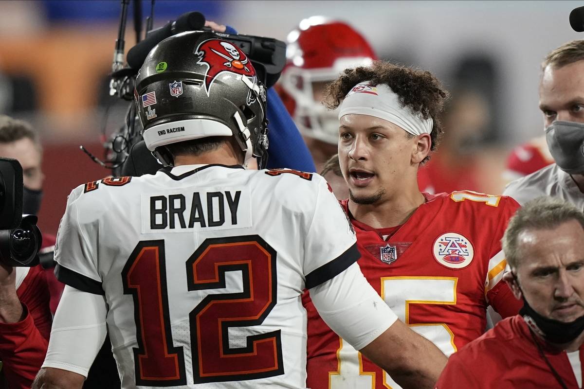 Tampa Bay Buccaneers quarterback Tom Brady, speaks with Kansas City Chiefs quarterback Patrick ...