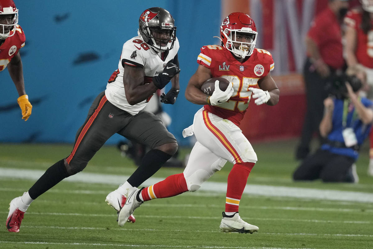 Kansas City Chiefs running back Clyde Edwards-Helaire, right, runs form Tampa Bay Buccaneers co ...