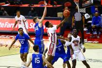 UNLV Rebels guard Bryce Hamilton (13) goes to the basket under pressure from Air Force Falcons ...
