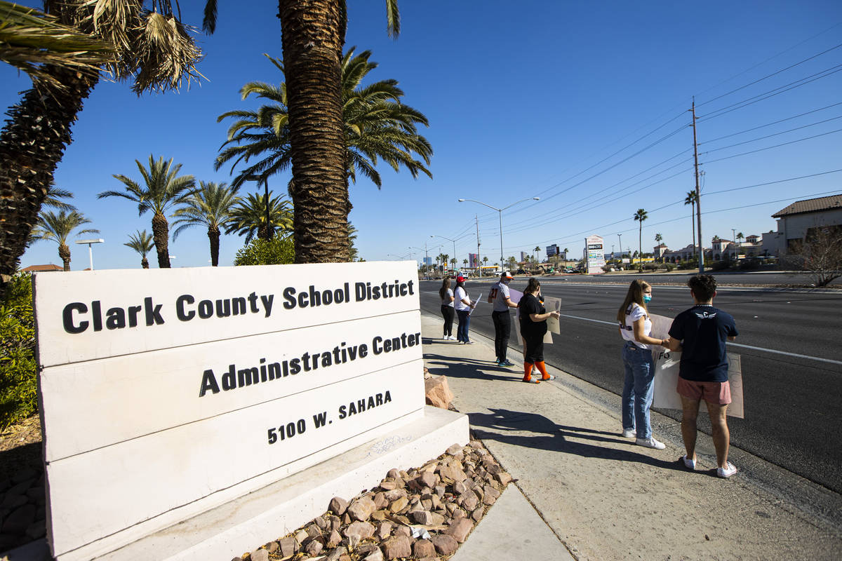 Student athletes and parents participate in a rally to urge school district officials to bring ...