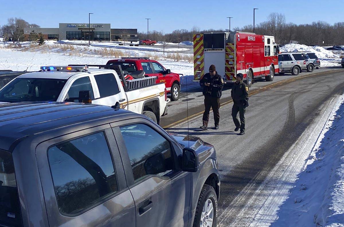 Law enforcement personnel and first responders gather outside of the Allina Health clinic, Tues ...