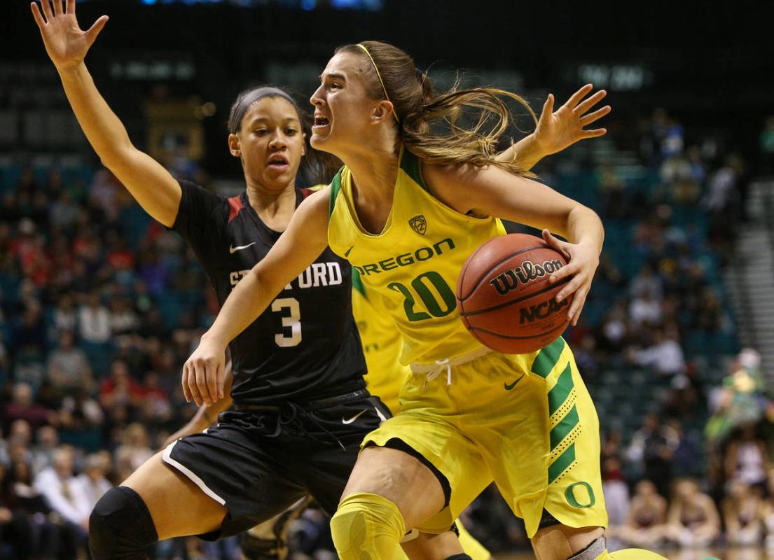 Oregon Ducks guard Sabrina Ionescu (20) looks to pass the ball while being guarded by Stanford ...