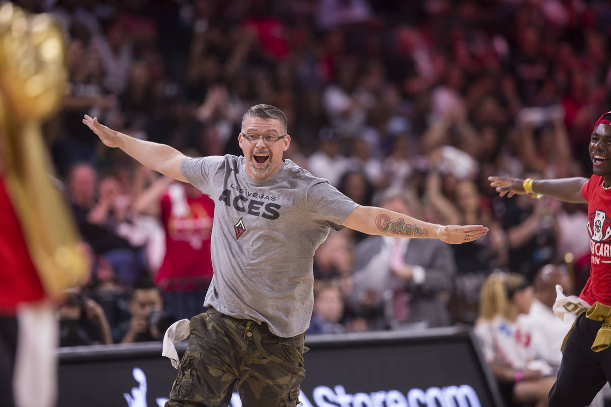 Russ Canty celebrates after winning a "pop-a-shot" contest during Vegas' WNBA semifin ...