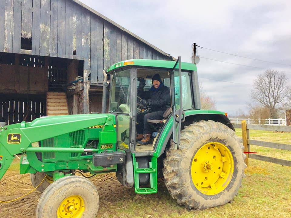 Lance Burton is shown on a John Deere 6120E compact tractor on his farm in Columbia, Kent., in ...