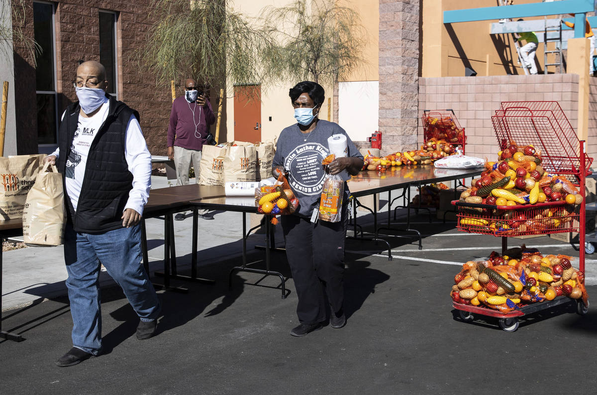 Brian Reese, left, and Archye Jett, a chef at the Martin Luther King Jr. Senior Center, prepare ...