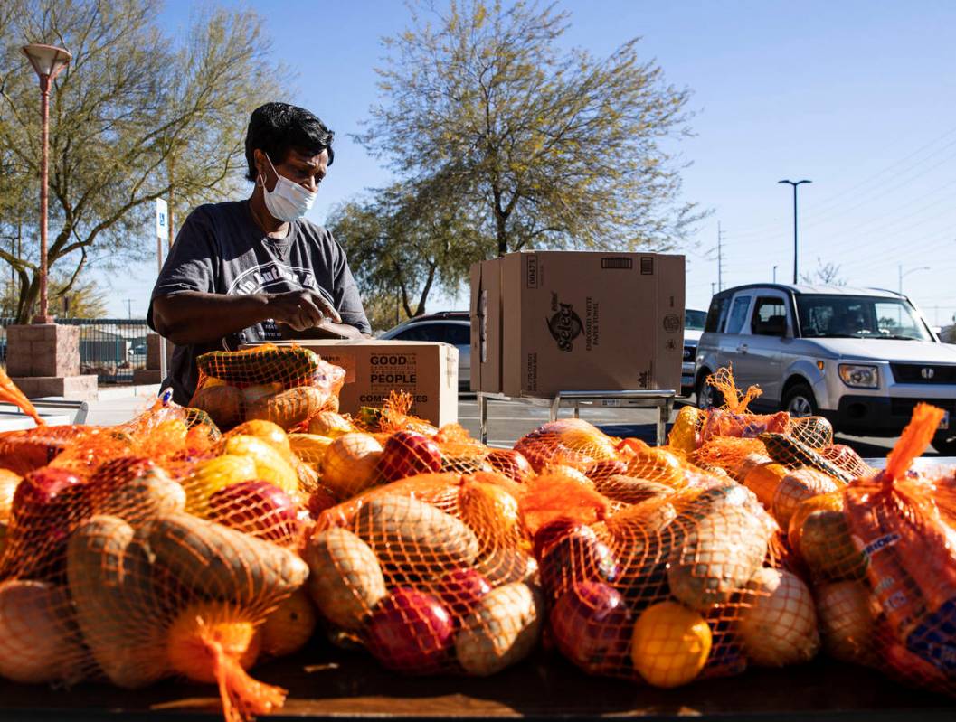 Archye Jett, a chef at the Martin Luther King Jr. Senior Center, prepares vegetables and fruits ...