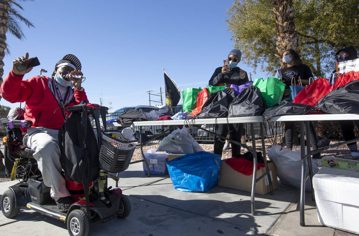 John McDaniel, "Soulful Johnnie," sings to New Era Las Vegas while they hand out food ...