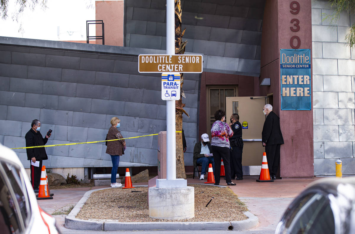 People wait in line for the first dose of the Moderna vaccine at a pop-up clinic at the Doolitt ...