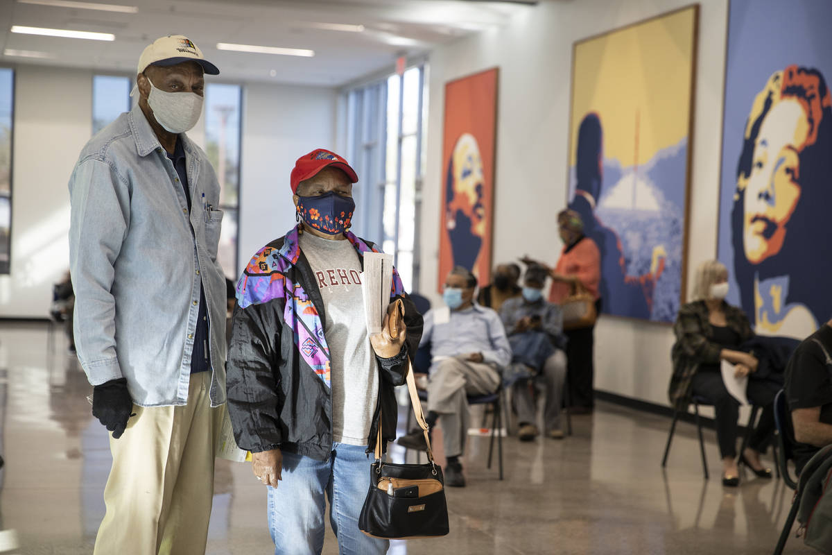 Ernest Conner, left, and his wife Henrietta Peterson, wait in line to get the COVID-19 vaccine ...