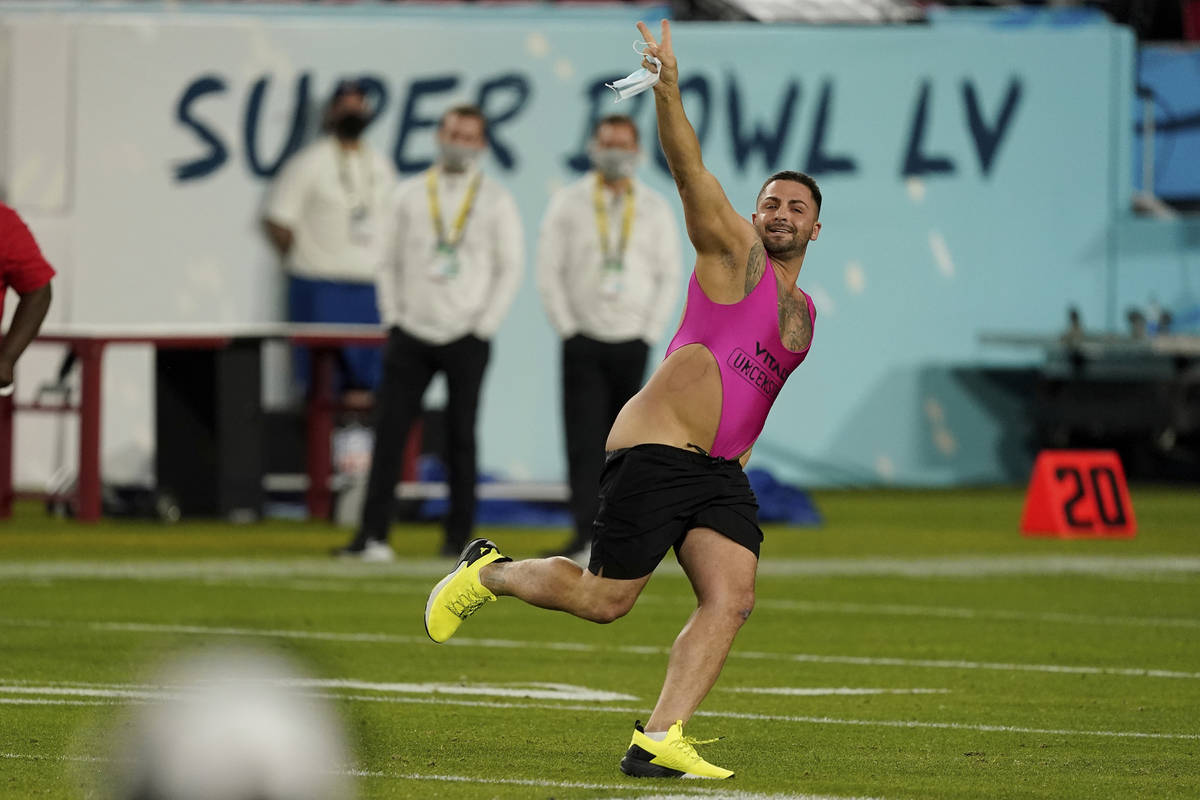 A fan runs on the field during the second half of the NFL Super Bowl 55 football game between t ...