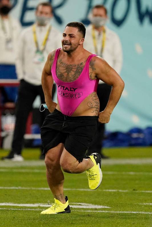 A fan runs on the field during the second half of the NFL Super Bowl 55 football game between t ...