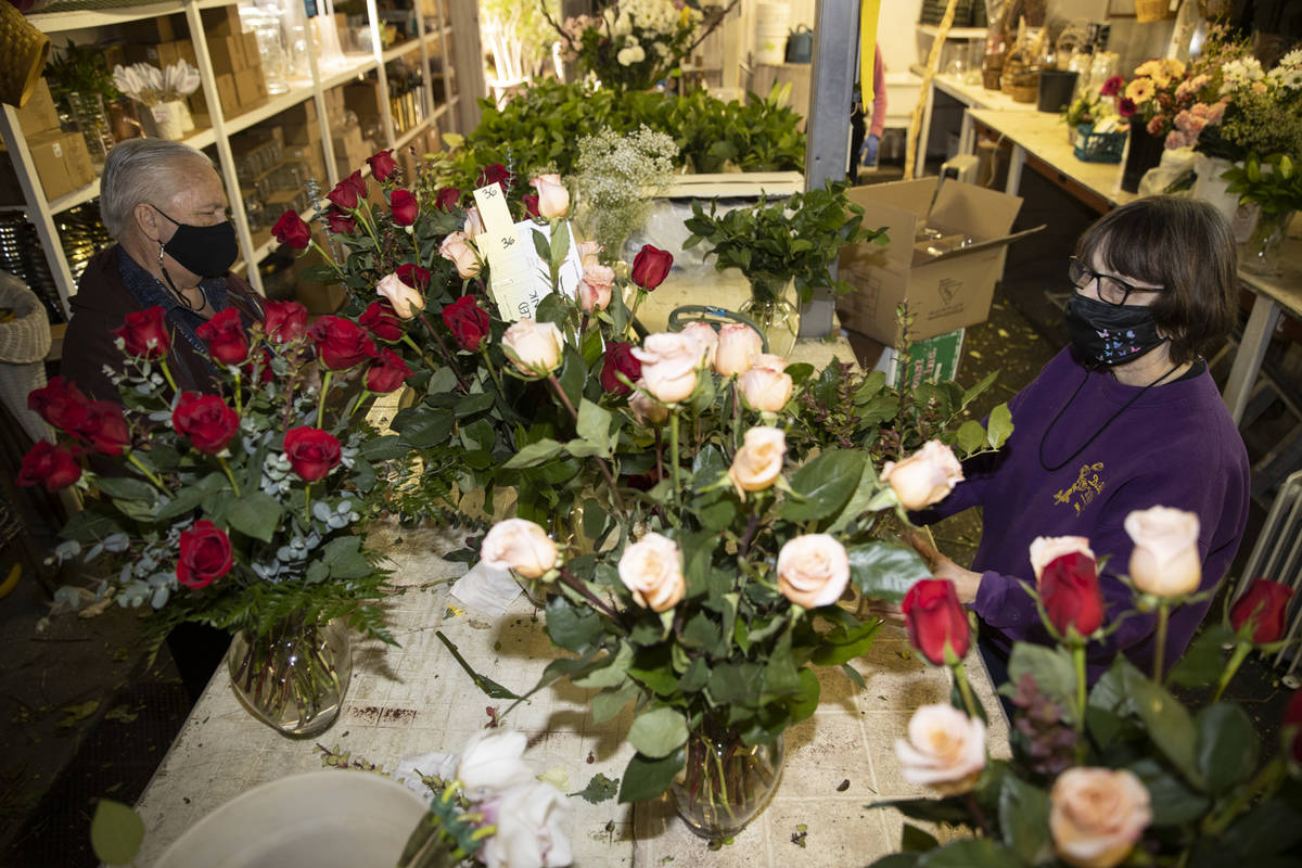 John DiBella, left, and his wife Susan, co-owners of DiBella Flowers & Gifts, assemble flow ...