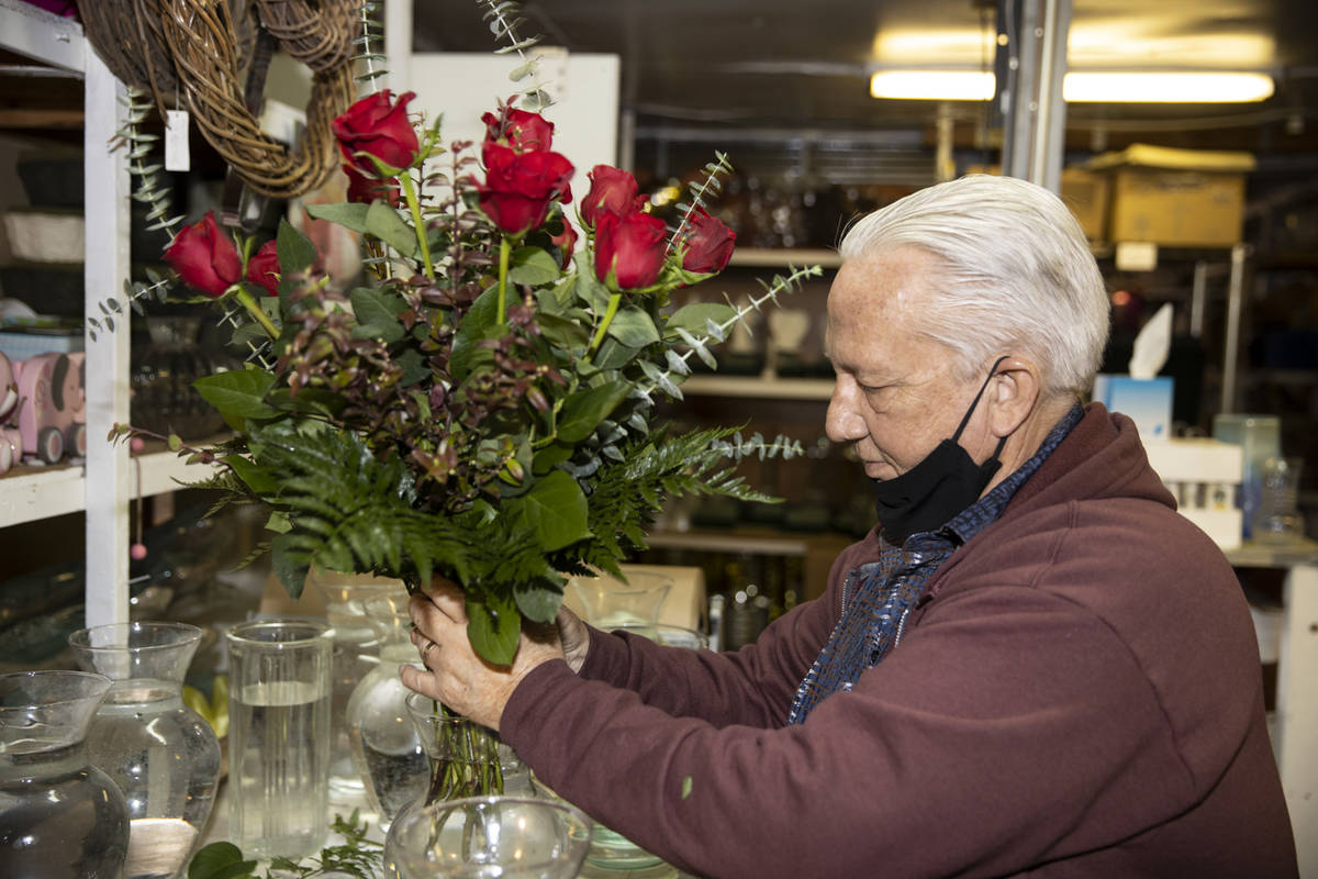 John DiBella, co-owner of DiBella Flowers & Gifts, assembles flower bouquets in preparation ...