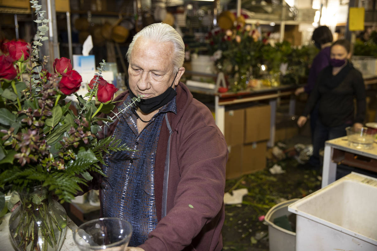 John DiBella, co-owner of DiBella Flowers & Gifts, assembles flower bouquets in preparation ...