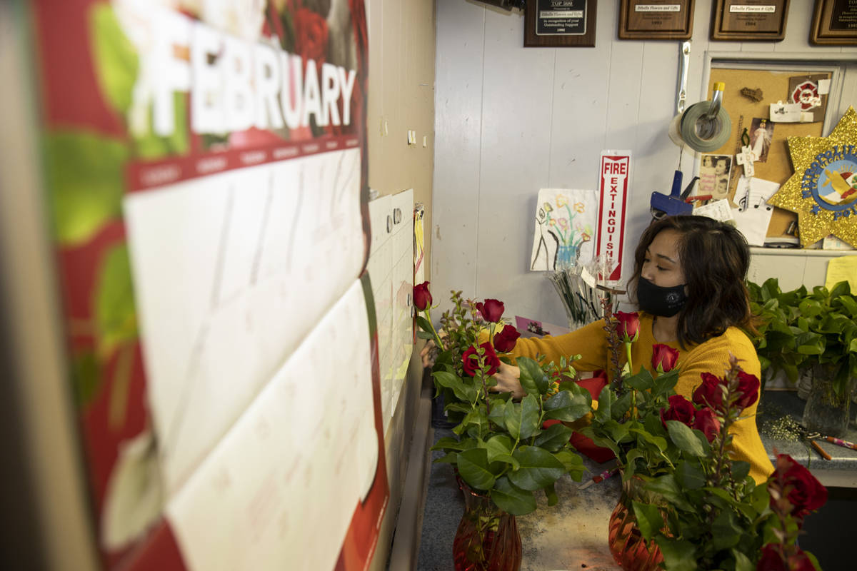 Sales person Kayla Sideco assembles flower bouquets in preparation of Valentine's Day at DiBell ...