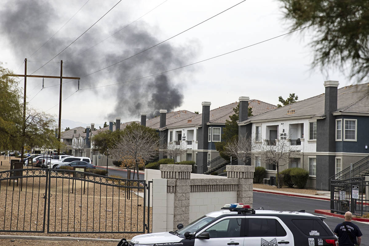 Black smoke is seen from an apartment at Milan Apartment Townhomes on East Silverado Ranch Boul ...