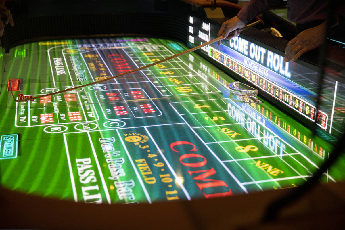 Table game dealer Alan Green handles dice on the new digital craps table, Rolls to Win Craps, a ...