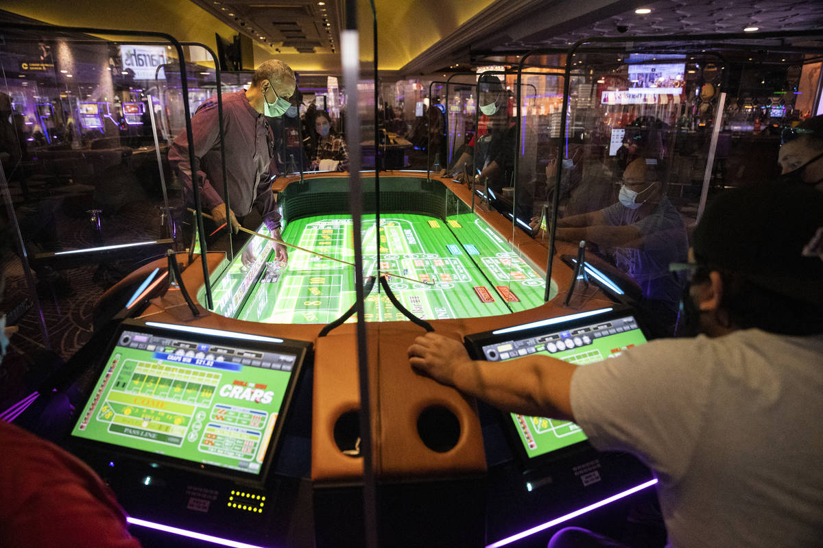 Table game dealer Alan Green handles dice on the new digital craps table, Rolls to Win Craps, a ...