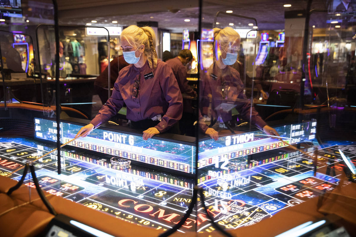 Table game dealer Valentina Chtchevelva handles dice with a stick on the new craps table, Rolls ...