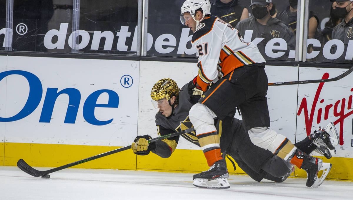 Golden Knights defenseman Dylan Coghlan (52) goes to the ice to control the puck past Anaheim D ...