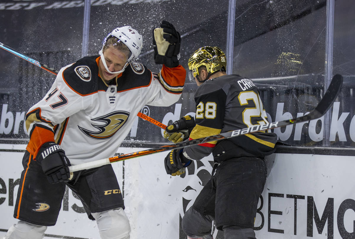 Anaheim Ducks defenseman Trevor Carrick (47) has his helmet rocked after a hard check from Gold ...