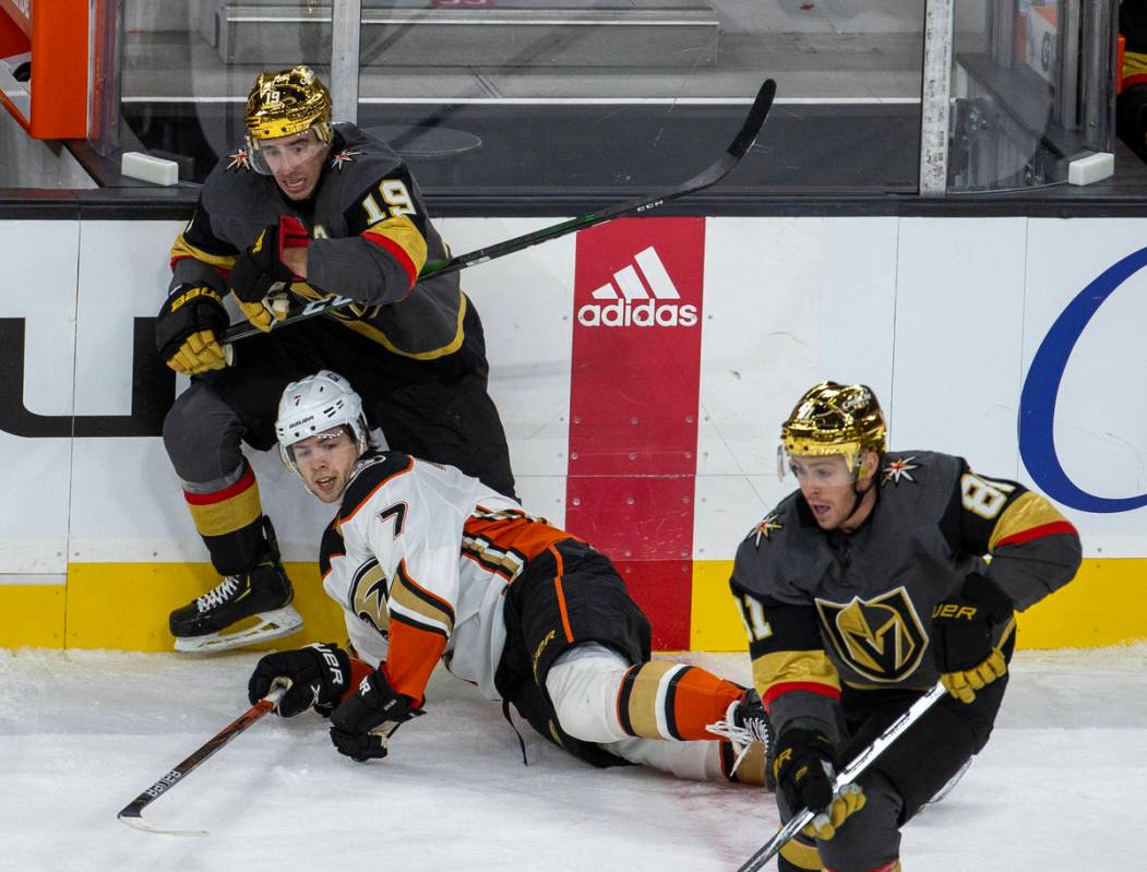 Golden Knights right wing Reilly Smith (19) and Anaheim Ducks defenseman Ben Hutton (7) tangle ...