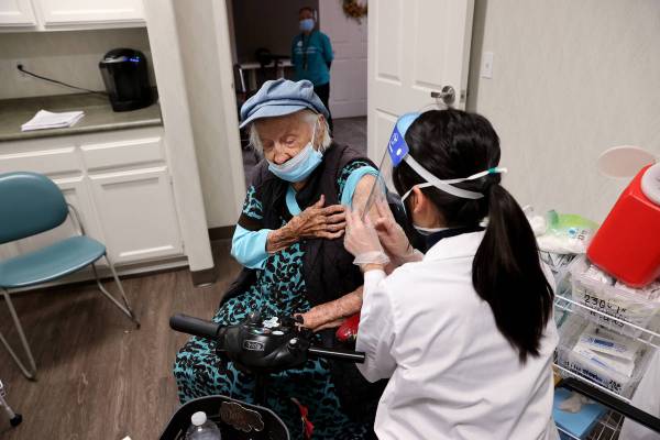 Valmae Ayres, 98, receives the Pfizer COVID-19 vaccine during an in-house clinic at Oakmont of ...