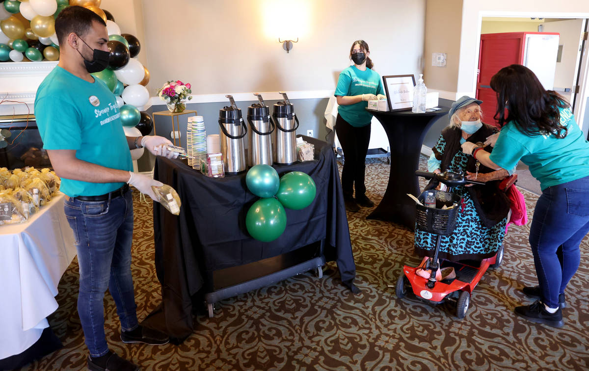 Valmae Ayres, 98, gets an "I was vaccinated today!" sticker after activity assistant ...