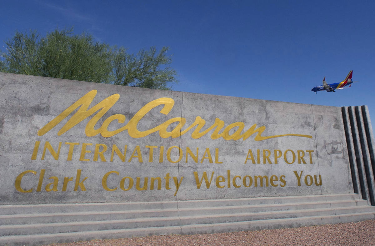 McCarran International Airport sign is seen as a Southwest Airways plane prepares to land in th ...