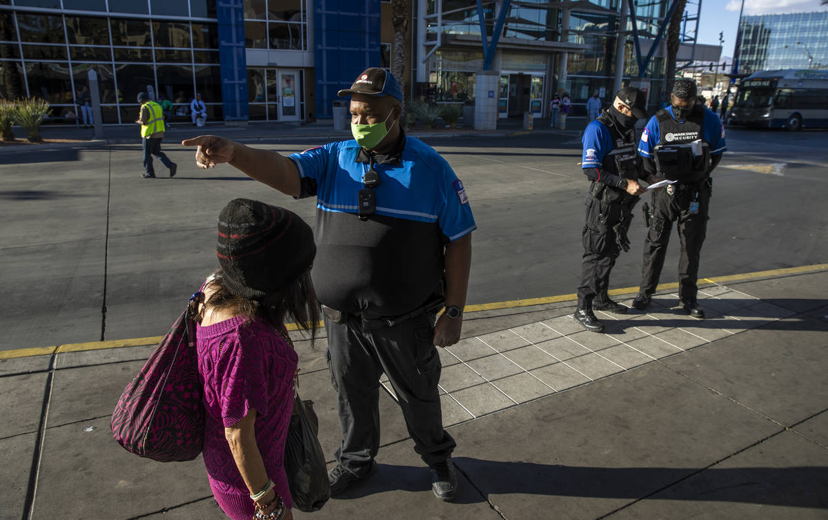 (From left) Security officer Robert Jackson directs a passenger as Area Commander William Tidma ...