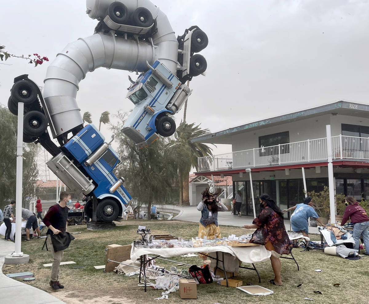 Vendors brace during sudden high winds at Fergusons Downtown in Las Vegas Saturday, Feb. 13, 20 ...