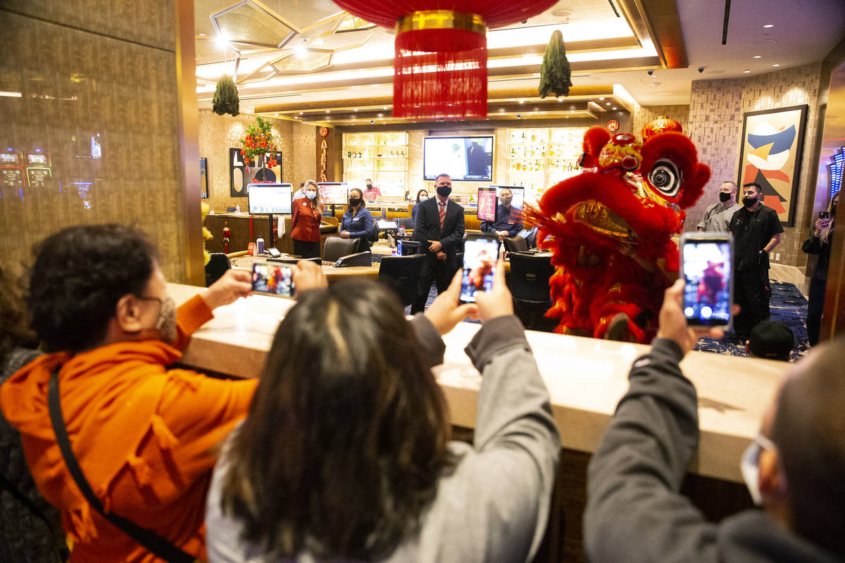 People watch The Lohan School of Shaolin perform the Chinese Lion dance in celebration of the L ...