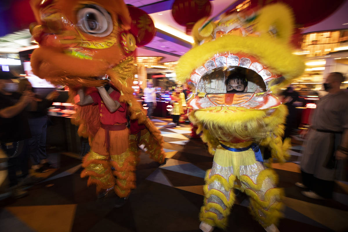 Michael Buenavista, right, with The Lohan School of Shaolin, performs the Chinese Lion dance in ...