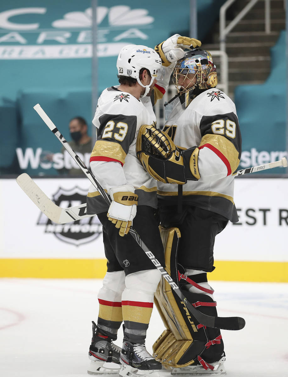 Vegas Golden Knights defenseman Alec Martinez (23) celebrates with Vegas Golden Knights goalten ...