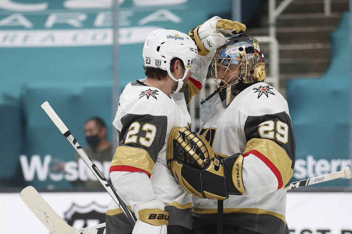 Vegas Golden Knights defenseman Alec Martinez (23) celebrates with Vegas Golden Knights goalten ...