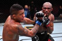 (R-L) Kamaru Usman of Nigeria punches Gilbert Burns of Brazil in their UFC welterweight champio ...