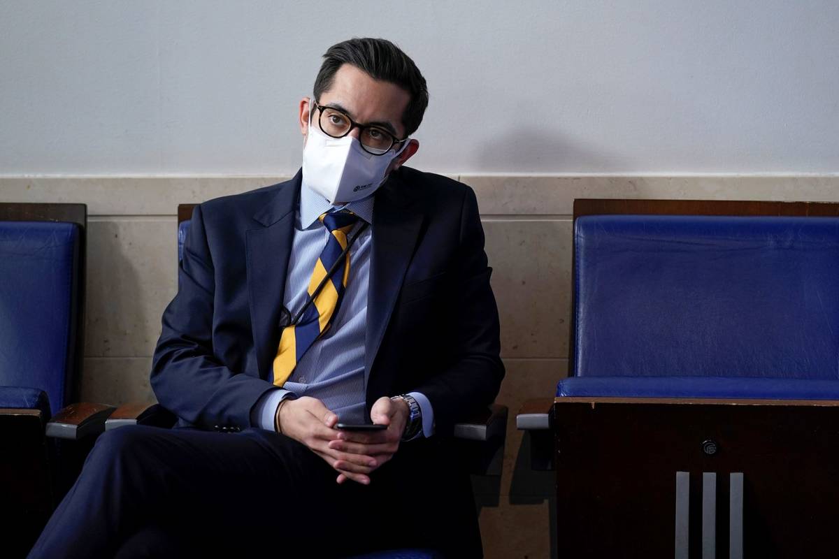 White House deputy press secretary TJ Ducklo listens as press secretary Jen Psaki speaks during ...