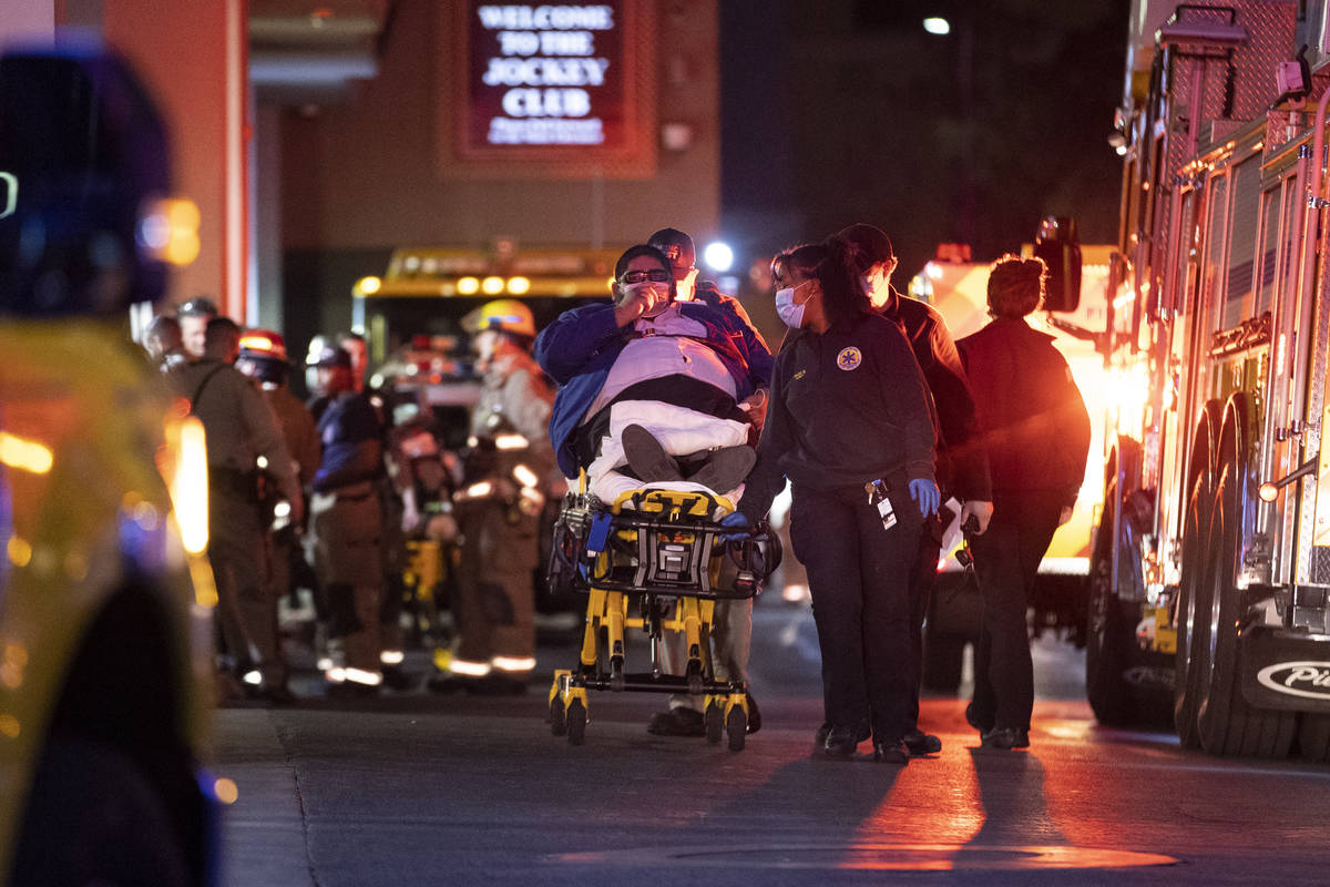 A person is taken on a stretcher after emergency crews responded to a 2 alarm “commercial fir ...