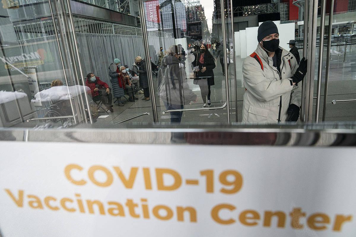 FILE - In this Wednesday, Feb. 3, 2021 photo, patients wait near the exit of a vaccination site ...