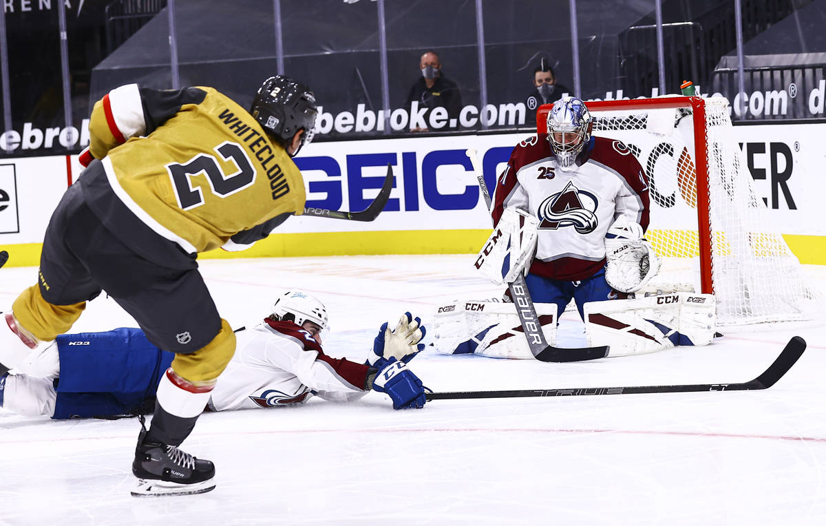 The puck flies past Colorado Avalanche goaltender Philipp Grubauer (31) after a shot by Golden ...