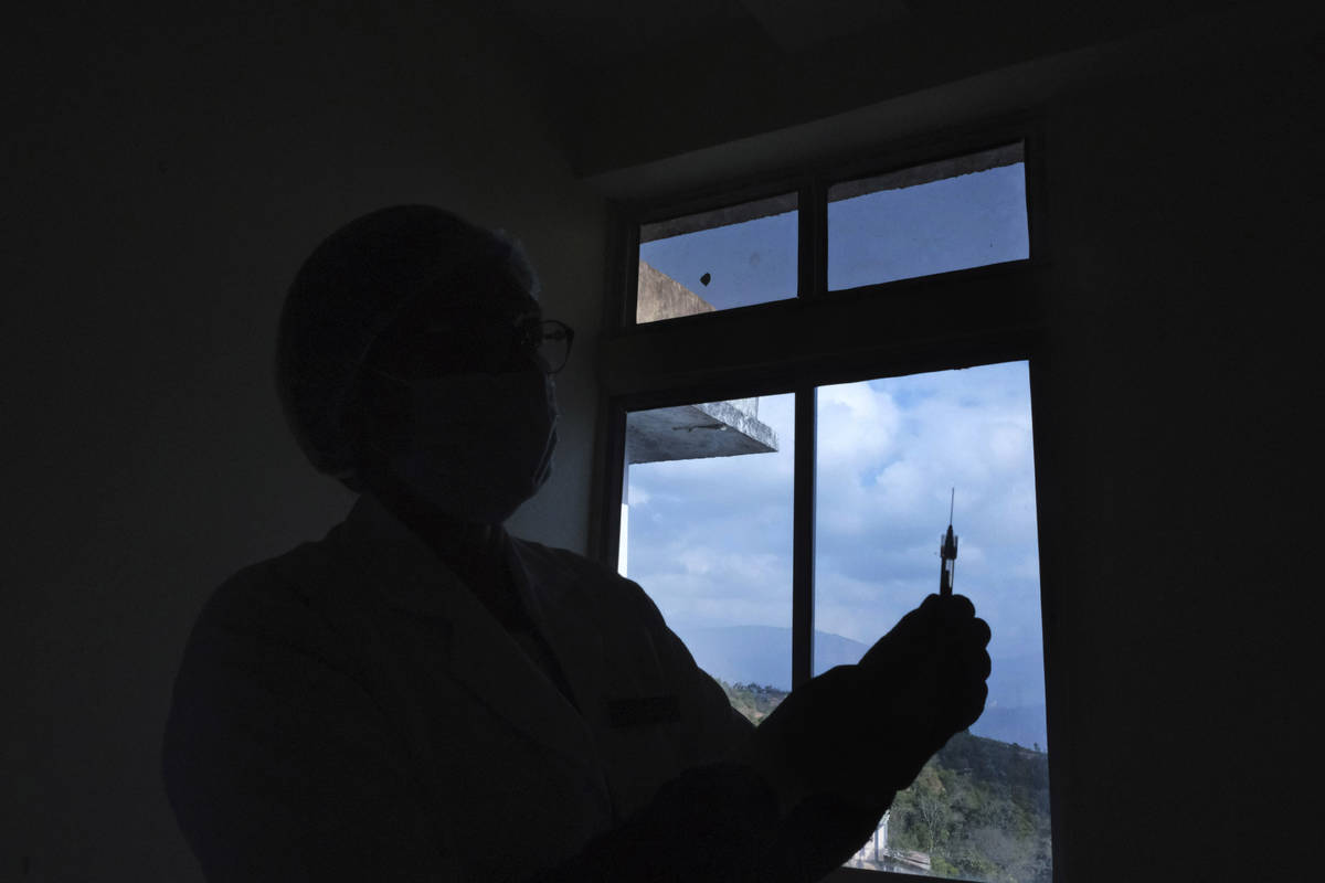FILE - In this Jan. 16, 2021, file photo, a nurse holds up the syringe containing COVID-19 vacc ...