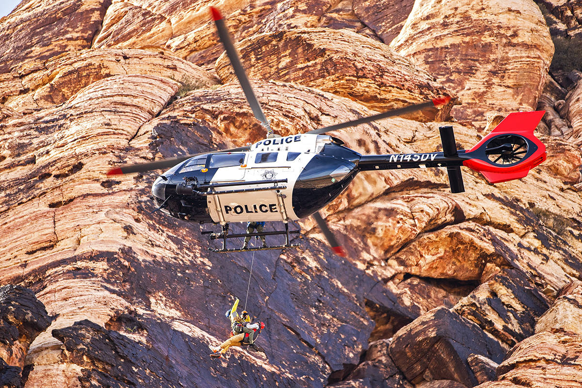 A climber is lifted to safety by Las Vegas Metropolitan Police Department search and rescue aft ...