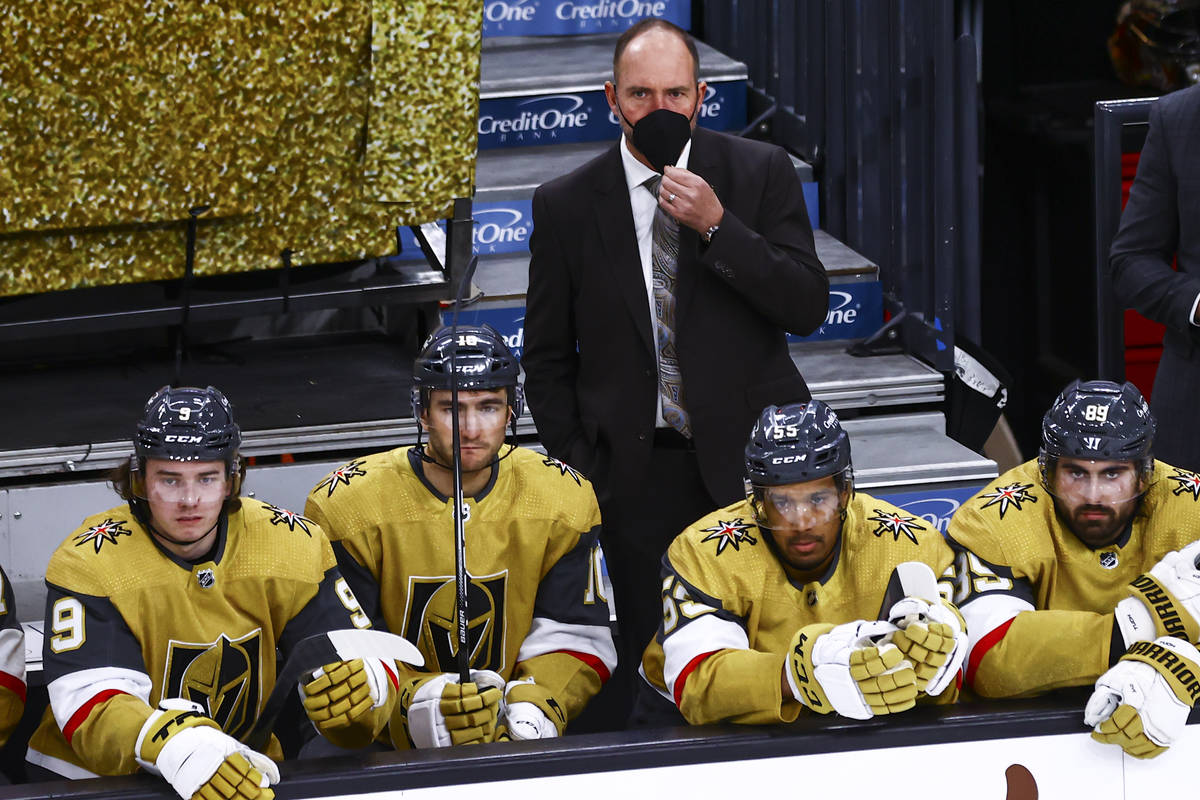 Golden Knights head coach Pete DeBoer looks on from the bench during the third period of an NHL ...