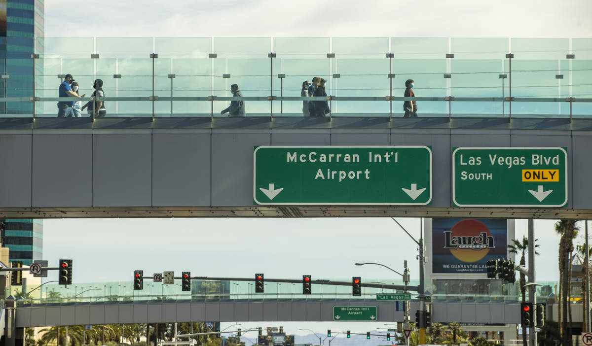 Signs for McCarran International Airport on the pedestrian bridges over Tropicana Avenue which ...