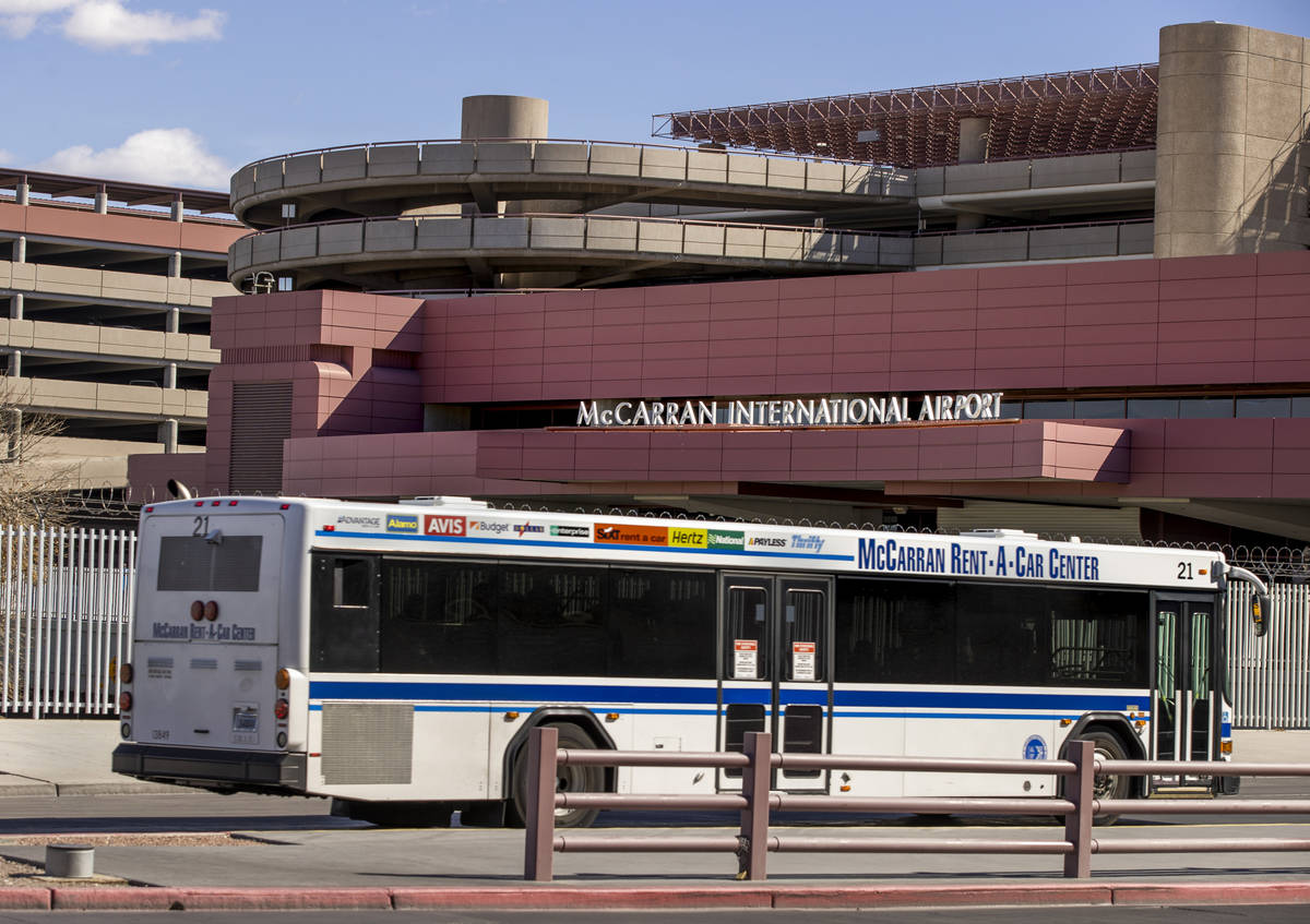 A rental car transport bus passes the Terminal 1 baggage area at McCarran International Airport ...