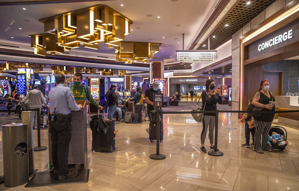 Visitors wait patiently in the slots area as someone checks in for them at the front desk withi ...