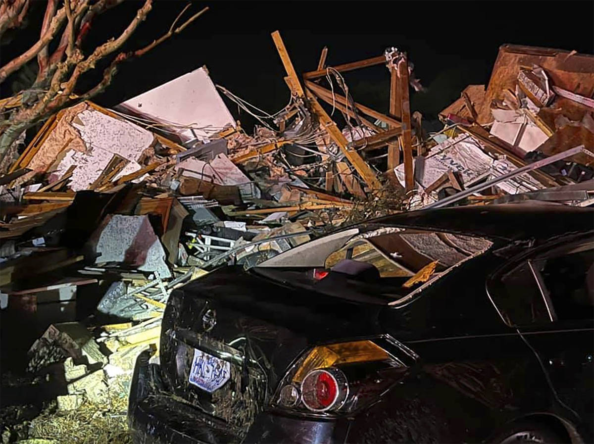 A damaged vehicle sits among debris after a deadly tornado tore through Brunswick County, N.C., ...
