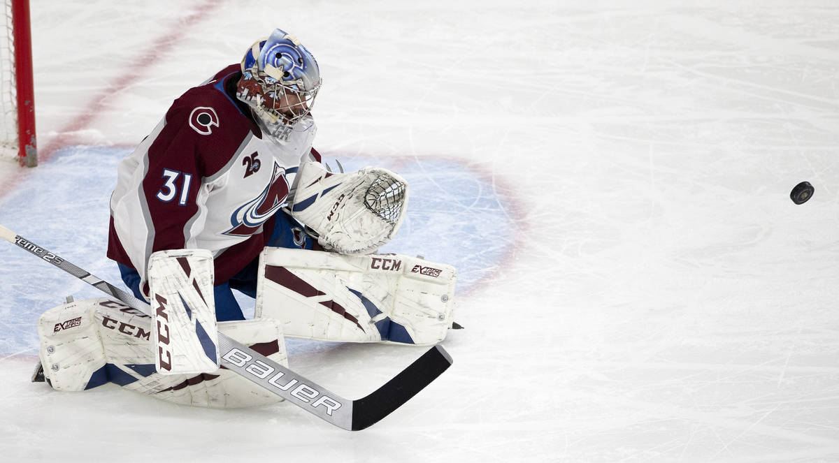 Colorado Avalanche goaltender Philipp Grubauer (31) is about to save a Golden Knights goal duri ...